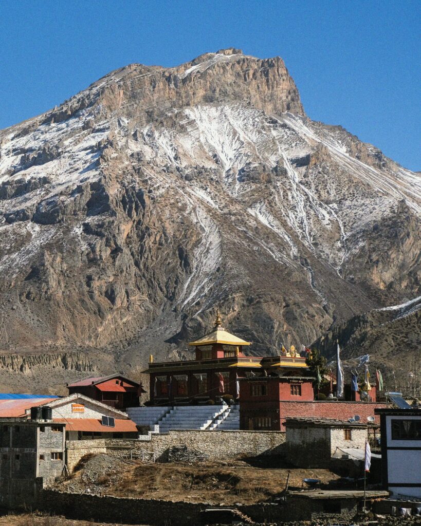 Stunning view of Муктинатх Monastery with the Himalayas towering behind, capturing the serene beauty of Nepal.